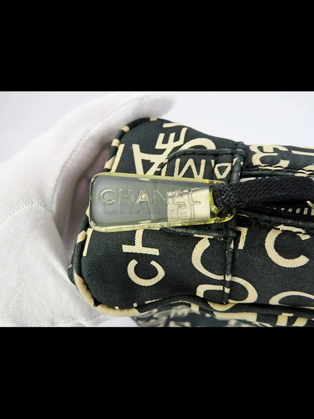 CHANEL Black Canvas Logo Print Cosmetic Pouch with Cream Lettering